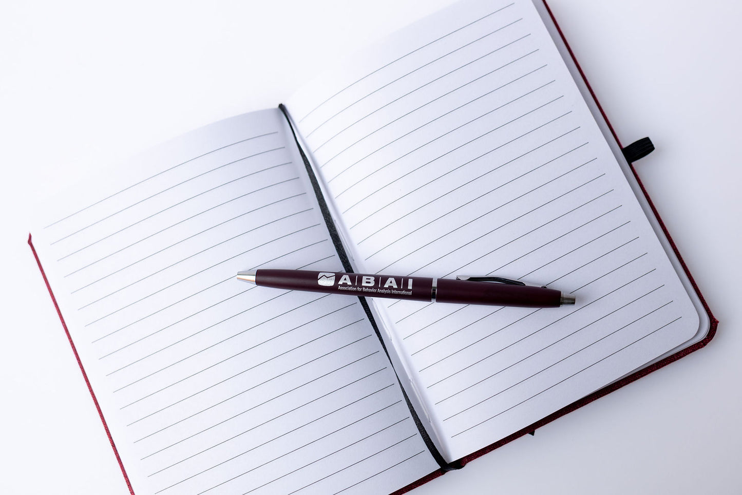 Maroon ABAI Notebook with Pen